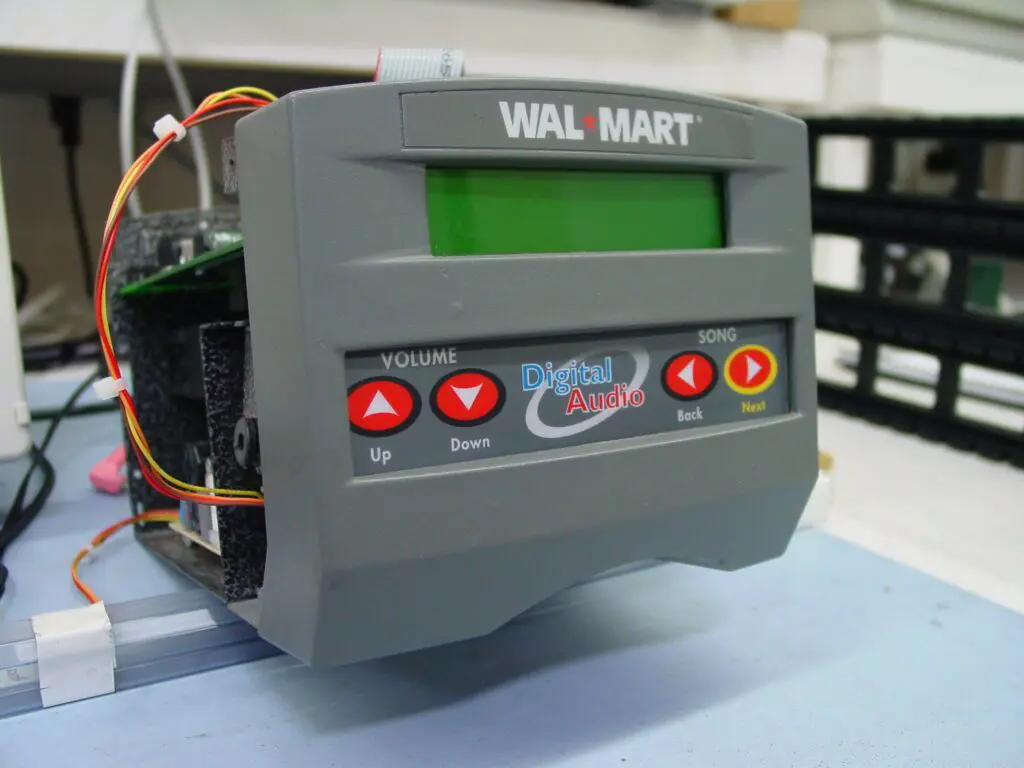 A close-up of a Walmart-branded electronic device with buttons and a display screen.