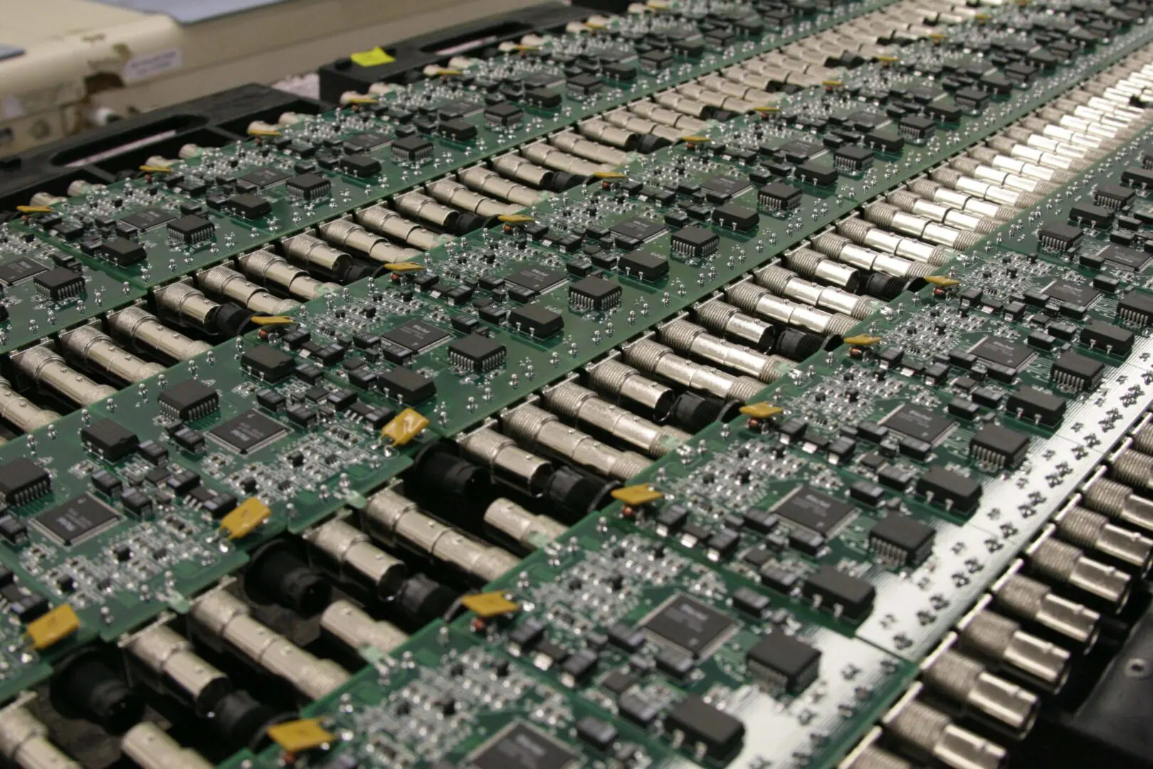 Rows of electronic circuit boards lined up for assembly or testing.